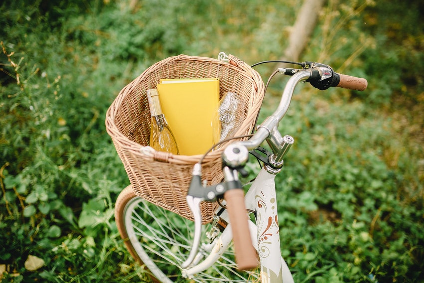 velo blanc avec panier en osier et bouteille de vin a linterieur