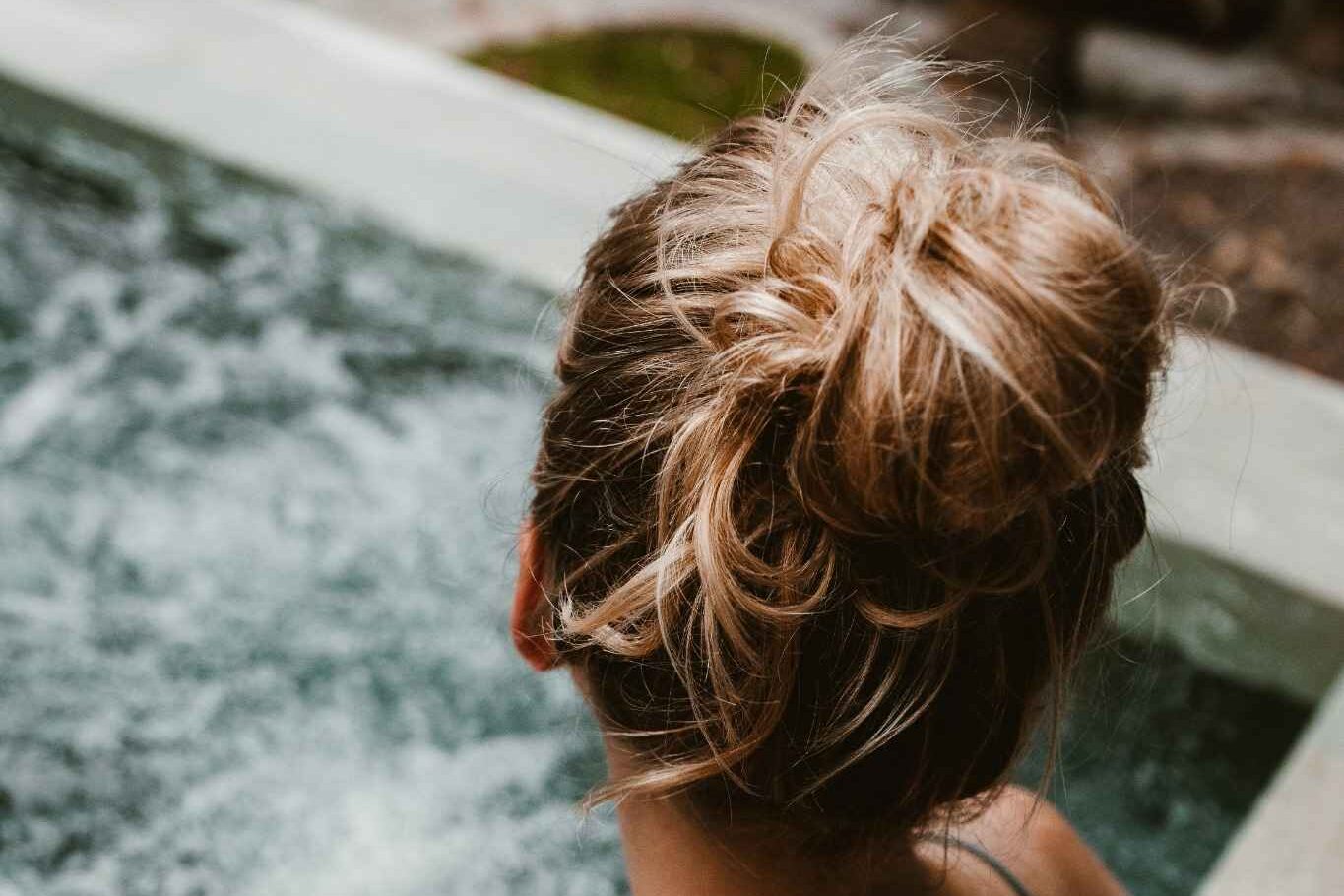 Femme de dos profitant d’un moment de détente dans un bain à remous lors d’une demi-journée thalasso à Deauville