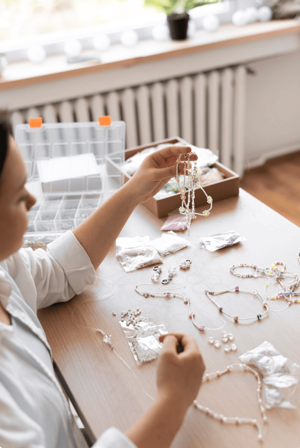 Participants à un atelier EVJF à Strasbourg en train de créer des bijoux en pâte Fimo, moment de concentration et de créativité entre amies