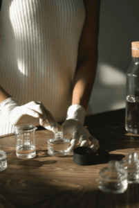 Flacons, pipettes et huiles essentielles utilisés lors d’un atelier parfum d’ambiance EVJF à Marseille, posés sur une table élégante