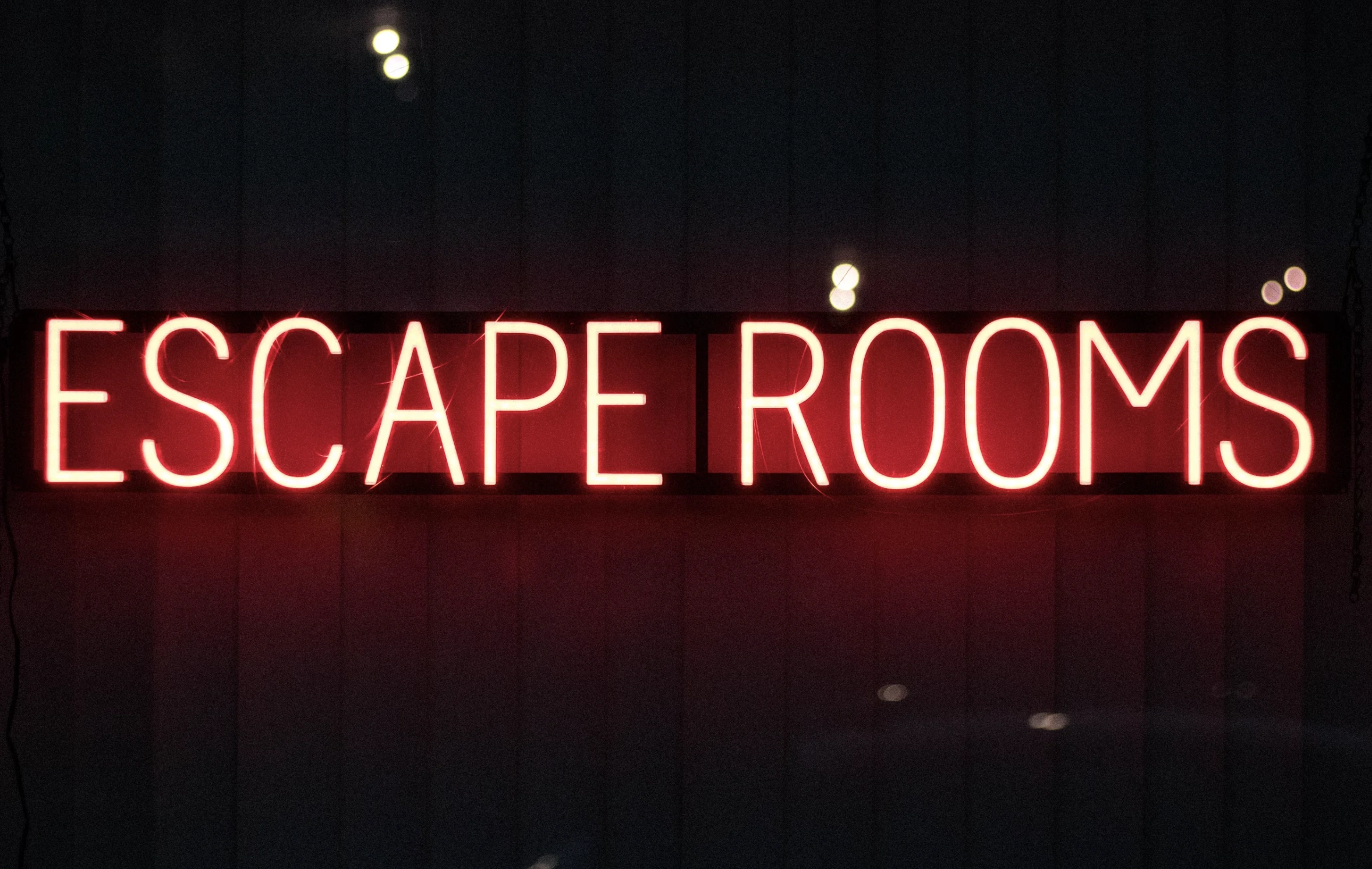 Groupe de femmes concentrées et collaboratives, résolvant des énigmes lors d’un escape game en intérieur