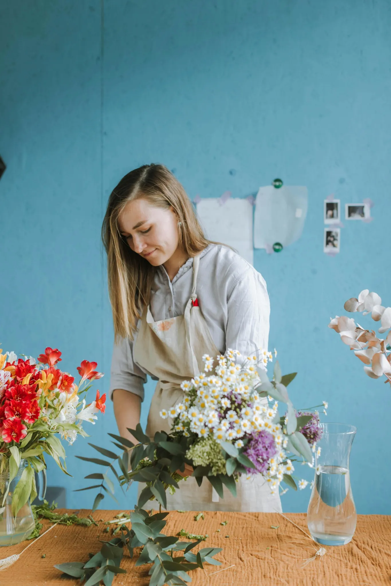 Femme arrangeant des fleurs blanches dans un vase lors d’un atelier floral à Tours