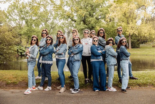 groupe de femmes en jean et lunettes pose dans un parc