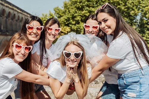 la future mariee entouree de ses amies en evjf pose en souriant pour illustrer 10 idees originales pour un evjf a montpellier