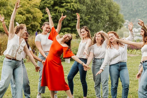 groupe de femmes riant et dansant en extérieur lors d’un evjf à annecy